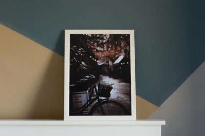 A modern room interior featuring a framed bicycle artwork with a cozy and artistic feel.
